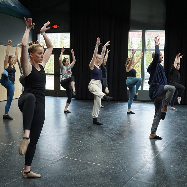 Photo from a Broadway Rose dance class showing our adult students during a short dance routine, theur arms in the arm and their right legs kicked up high.