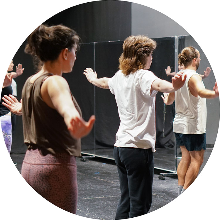 Photo from one of our Adult Dance classes showing the students mid dance number, posing with their arms out to their sides.