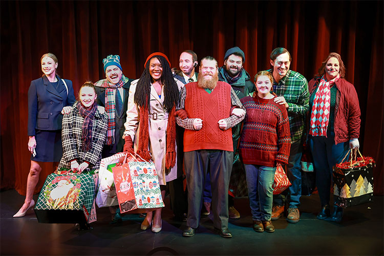 Photo from Five Golden Rings of the cast at the end of the opening song, all posed together in a group and smiling out to the audience.