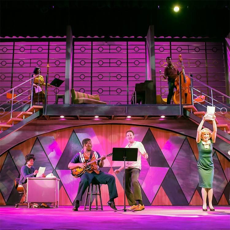 Photo of our recent 2024 summer production of Beautiful The Carole King Musical, one of our biggest shows ever. The photo shows a moment from the song 1650 Broadway when the ensemble is spread across the whole stage stage, up on raised platforms, and dancing to a medley of 1950s hits.