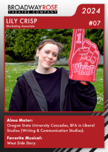 A sports card with a photo of Lily Crisp holding a large red foam finger that says we're number one on it. The text on the card reads... Alma Mater: Oregon State University Cascades, BFA in Liberal Studies (Writing & Communication Studies). Favorite Musical:West Side Story.