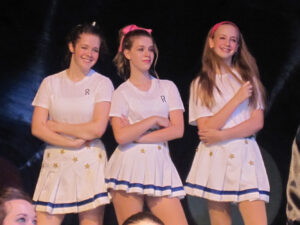 Photo of Allison Burke with two other teens in the 2009 Broadway Rose production of Grease.