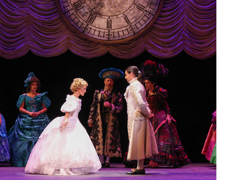 Photo of the Cinderella cast during the ball scene, Cinderella curtsying for the prince.